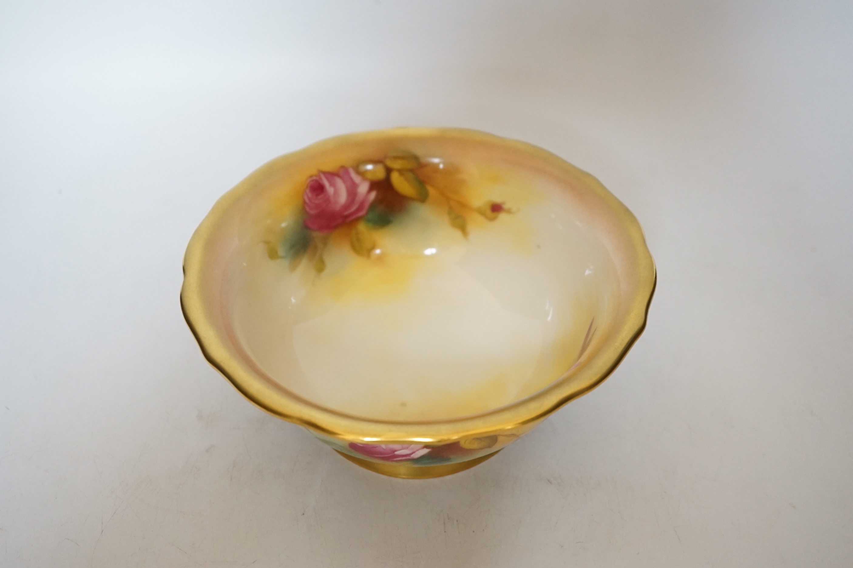 A Royal Worcester bowl decorated with roses, signed M Hunt, 8cm